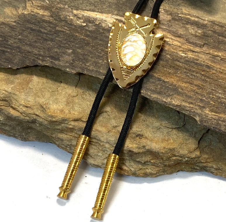 Lightweight golden arrowhead bolo with gold and white stone
