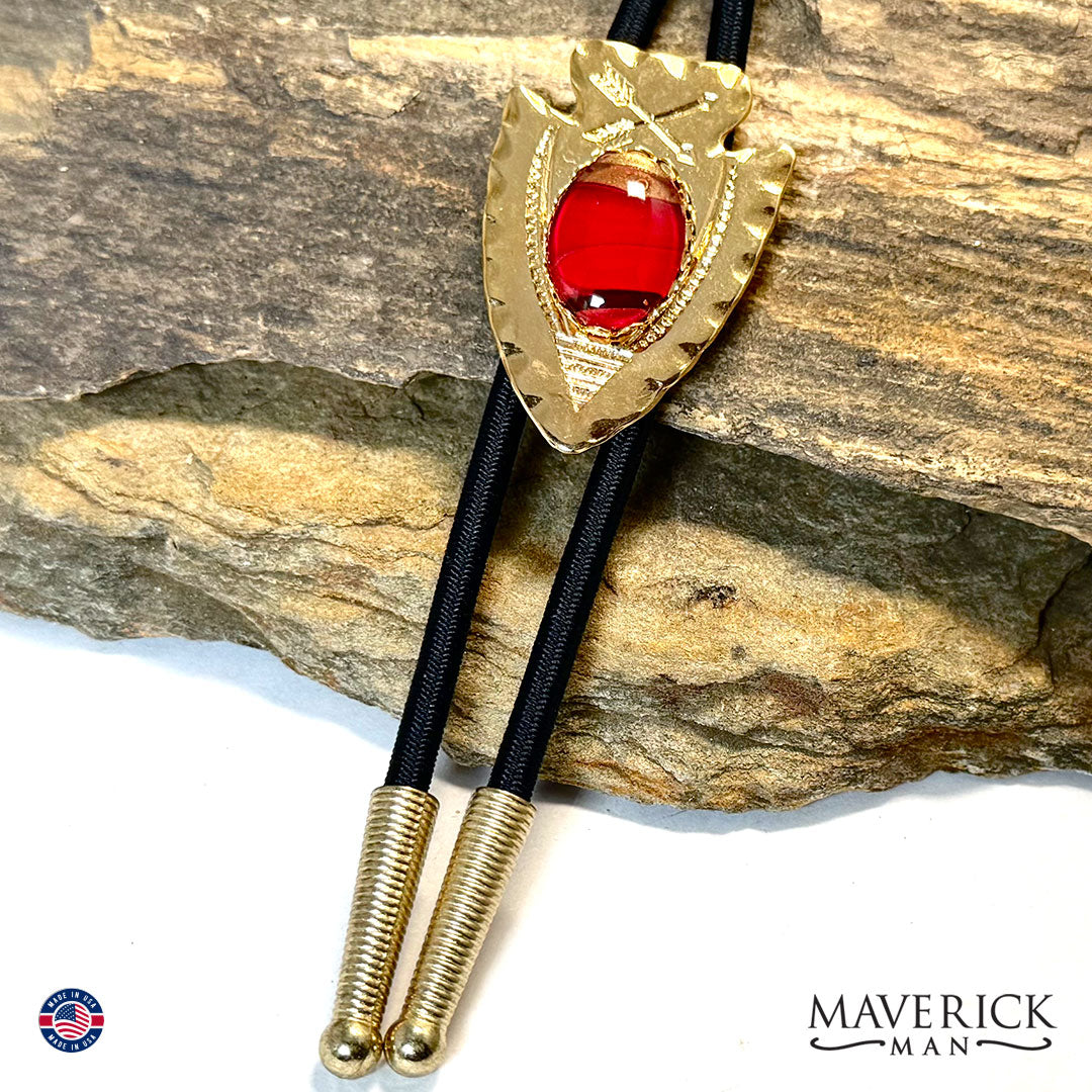 Golden arrowhead bolo tie with hand painted stone
