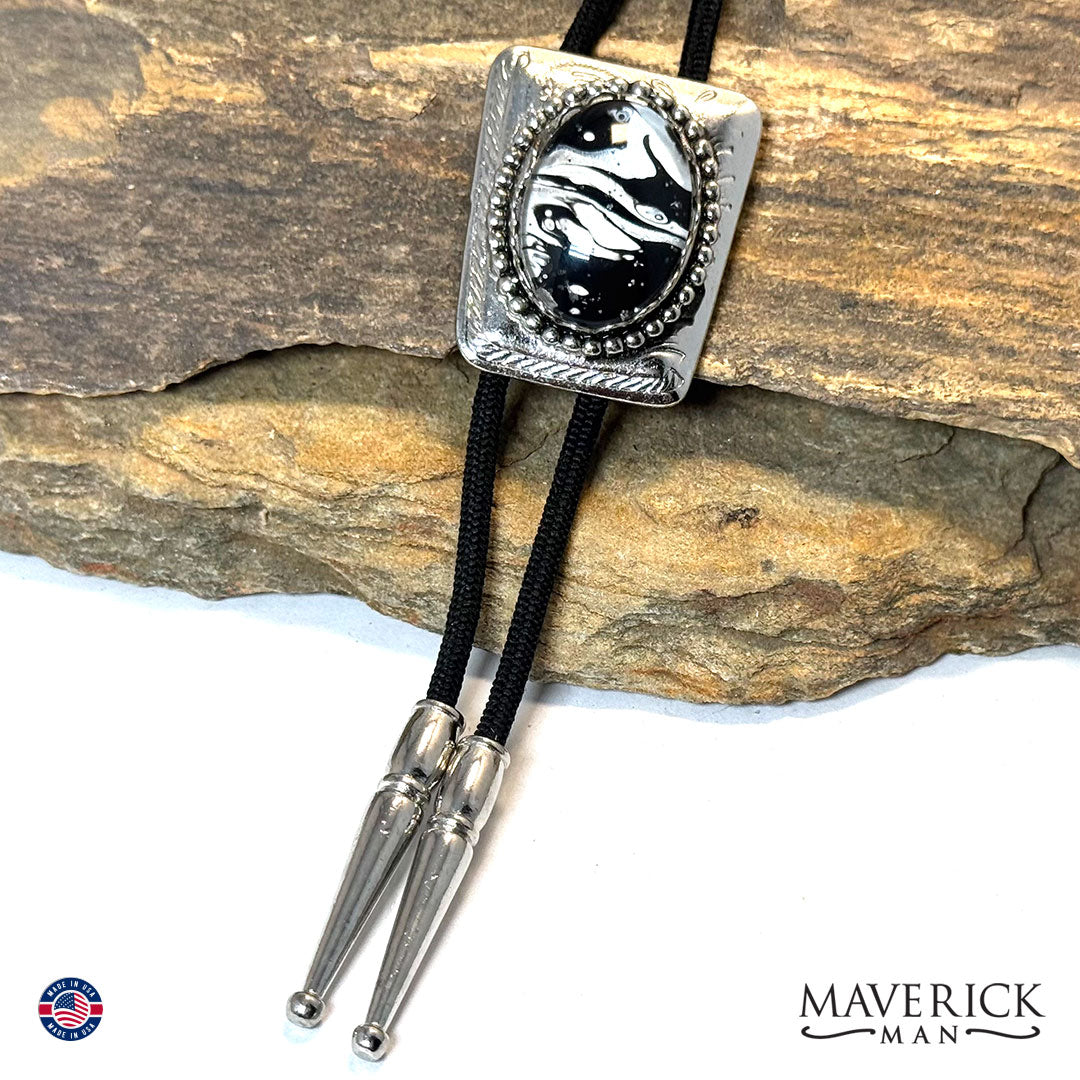 Silver bolo tie with hand painted black and white stone