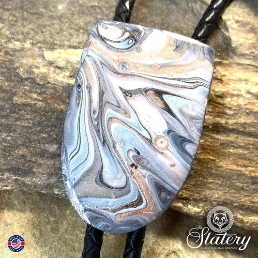 Handsome black and white bolo tie with rose gold accents