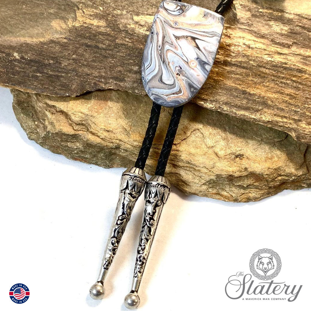 Handsome black and white bolo tie with rose gold accents