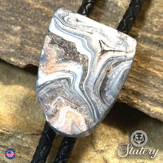 Handsome black and white bolo tie with rose gold accents