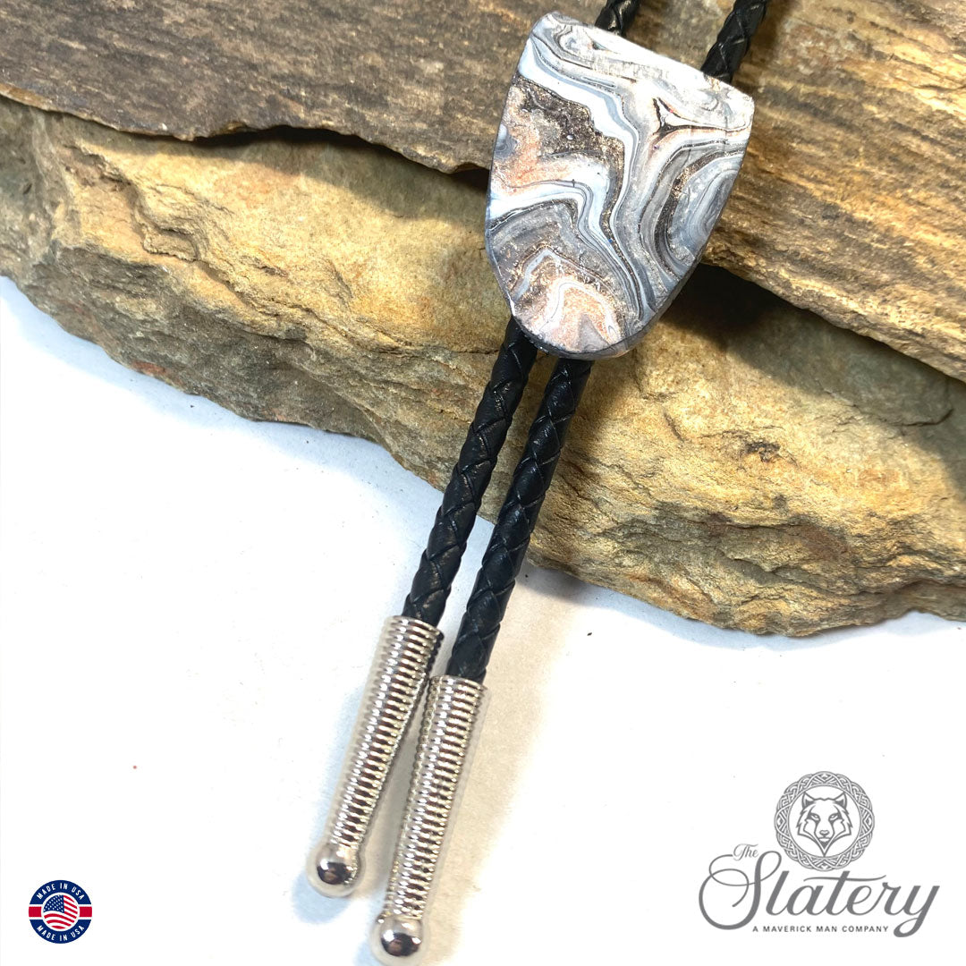 Handsome black and white bolo tie with rose gold accents