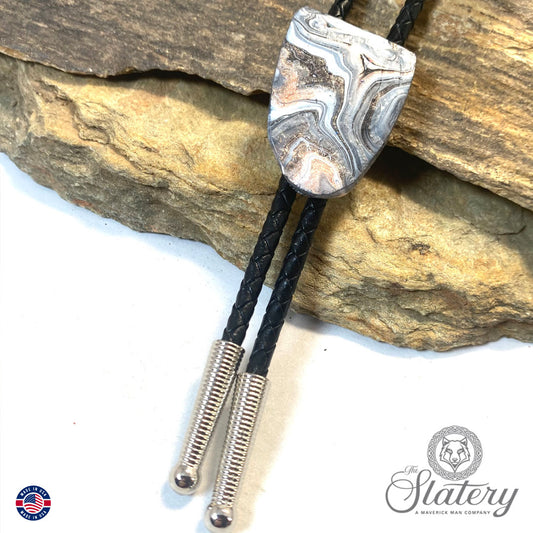 Handsome black and white bolo tie with rose gold accents