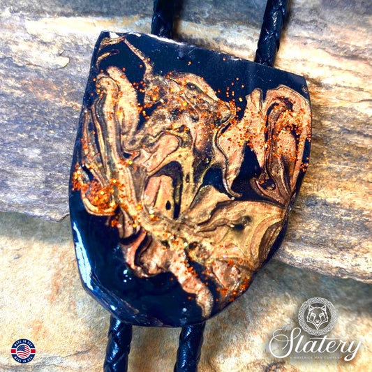 Rich earthtones and black on bolo tie made from slate