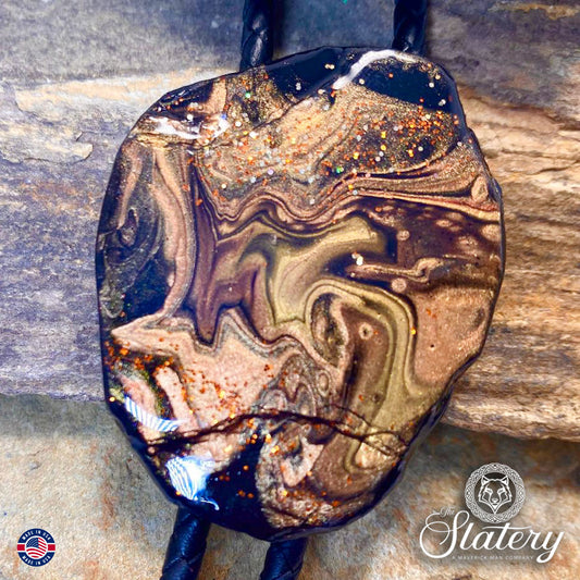 Rich earthtones and black on bolo tie made from slate