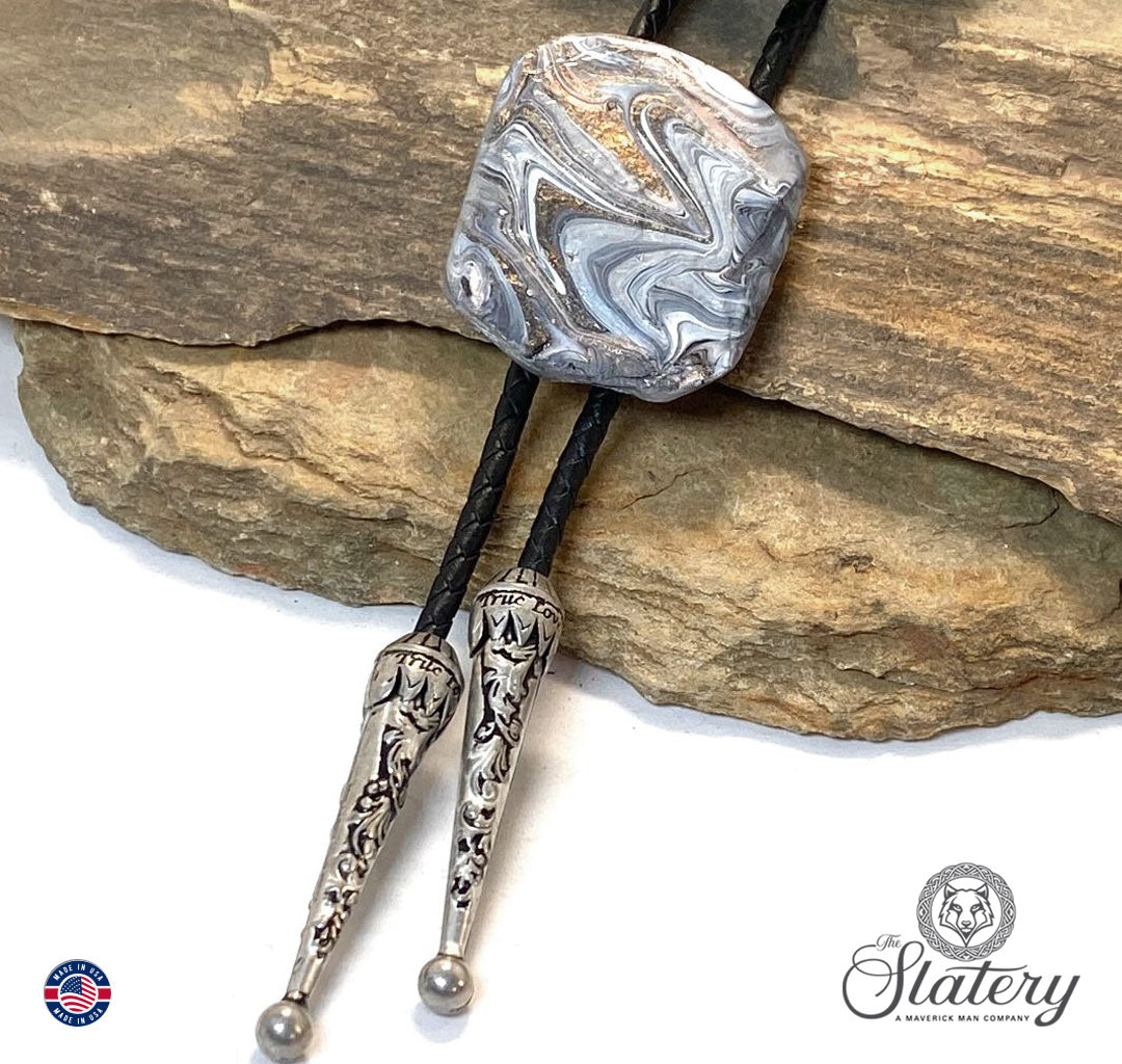 Unusual black and white bolo tie with rose gold accents