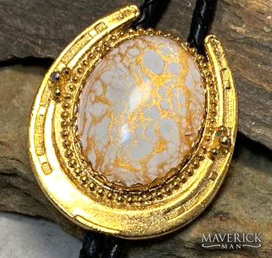 Dressy horseshoe bolo with gold and white stone with fancy tips