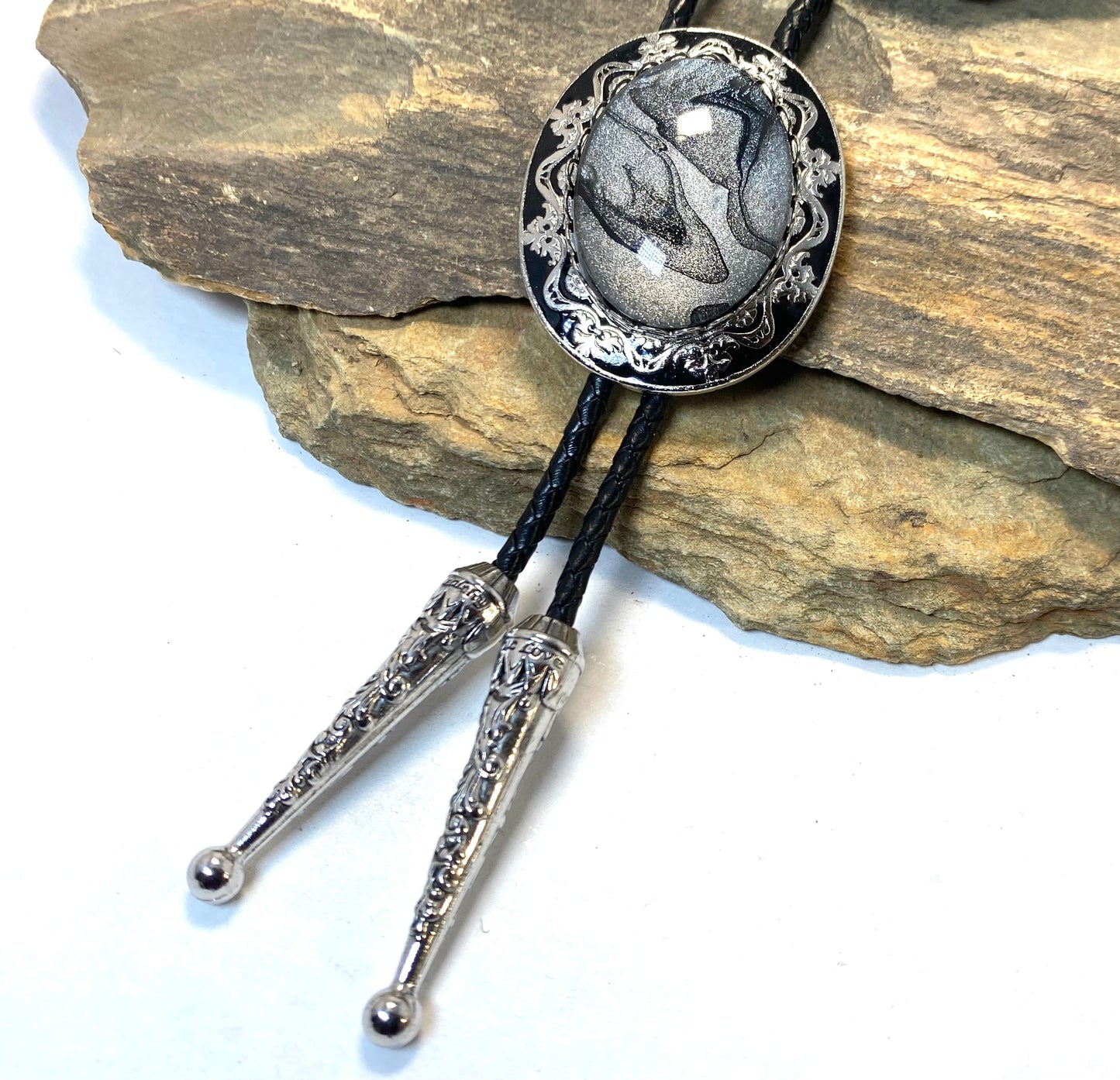 Large dressy bolo with handsome black and platinum hand painted stone no