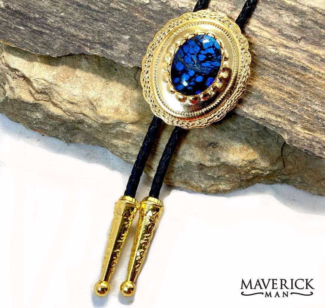 Sapphire and black hand painted stone set into golden concho bolo