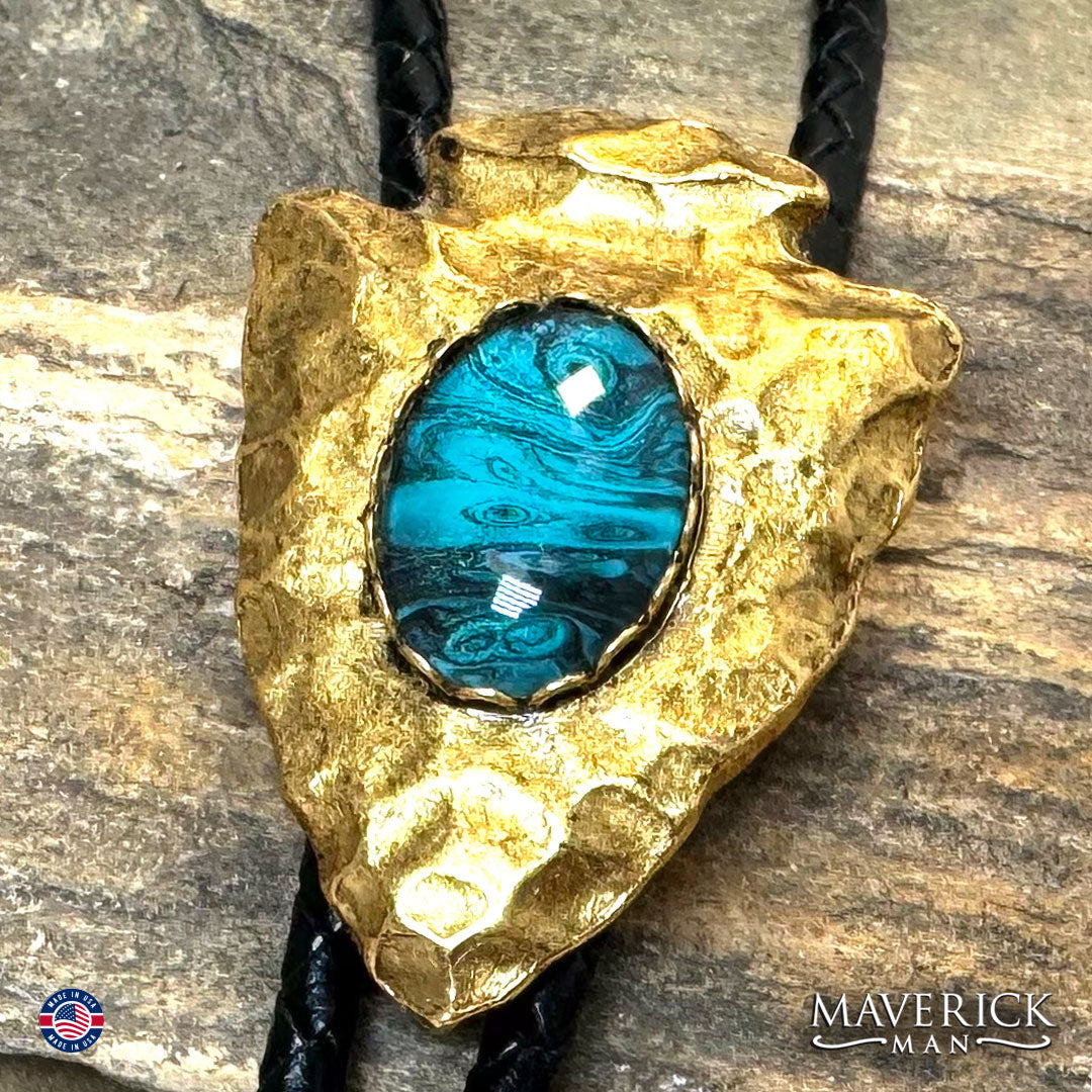 Golden arrowhead bolo tie with hand painted stone