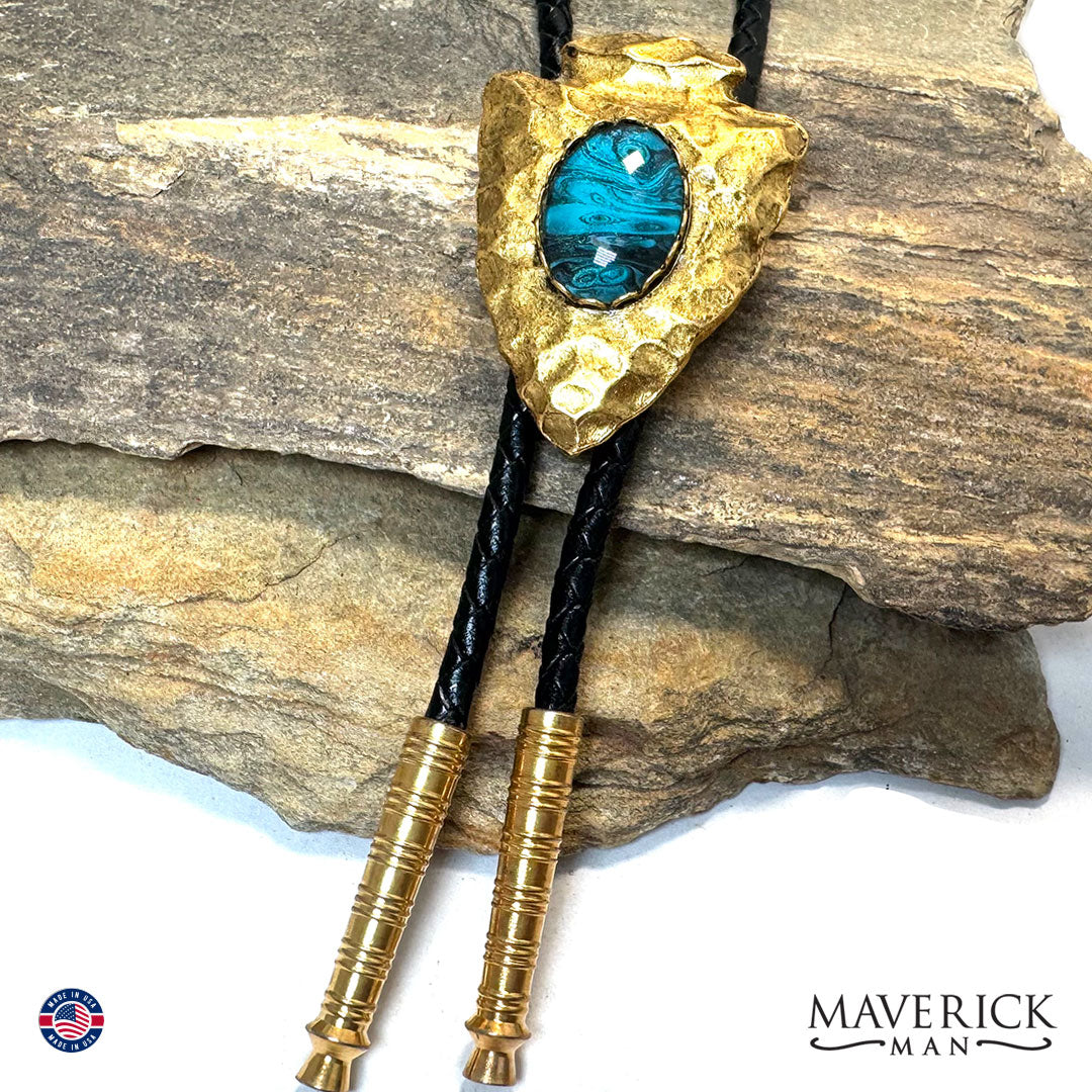 Golden arrowhead bolo tie with hand painted stone