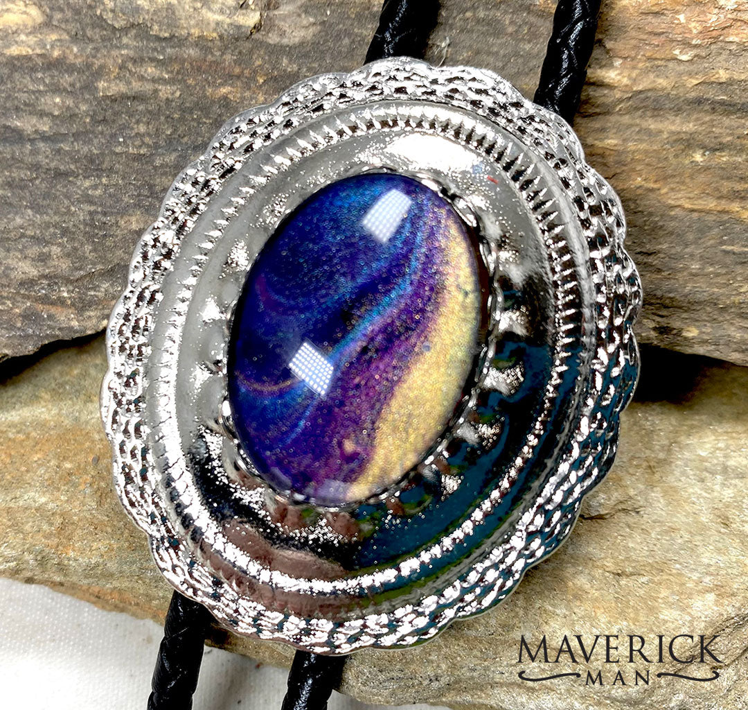 Purples blues and gold hues in a silver concho bolo