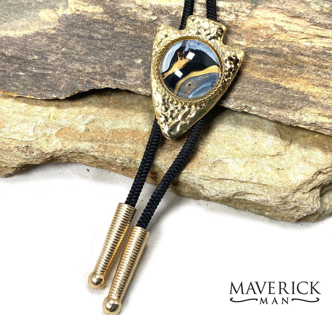 Golden, hammered arrowhead bolo with gold and black hand painted stone