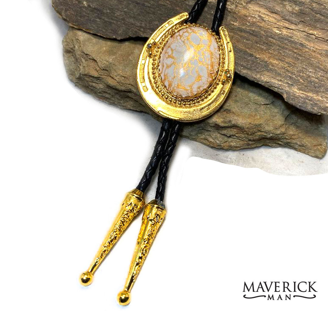 Dressy horseshoe bolo with gold and white stone with fancy tips